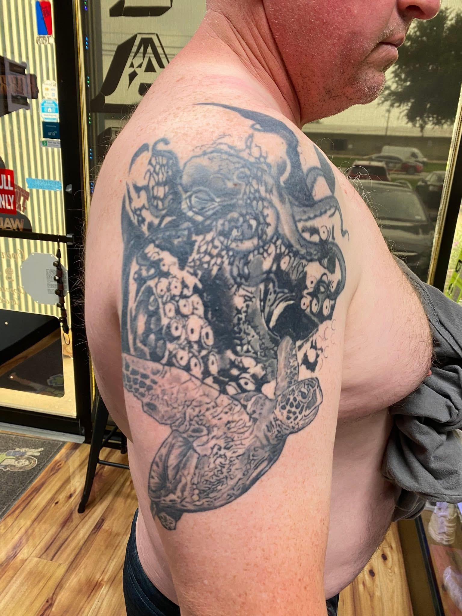 Faded black and grey octopus and sea turtle tattoo before the cover-up